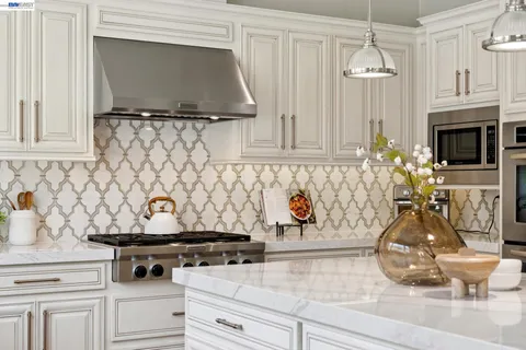 a bathroom with a granite countertop sink and mirror
