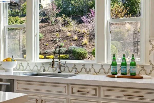 a dining room with furniture a chandelier and wooden floor