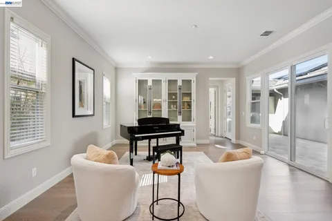 a living room with furniture and a piano