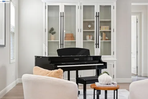 a living room with furniture a table and wooden floor