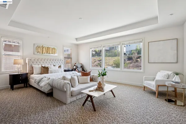 a living room with furniture a flat screen tv and a large window