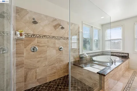 a bedroom with a large bed and a potted plant