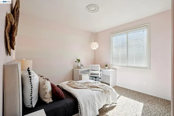 a bedroom with a bed and a chandelier