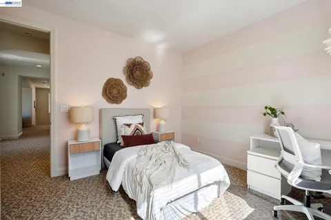 a bed room with a bed and a chair