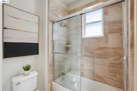 a living room with furniture a rug and a flat screen tv