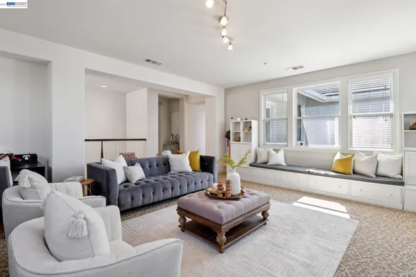 a living room with furniture and a potted plant