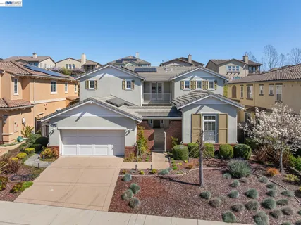 a view of a house with swimming pool and sitting area