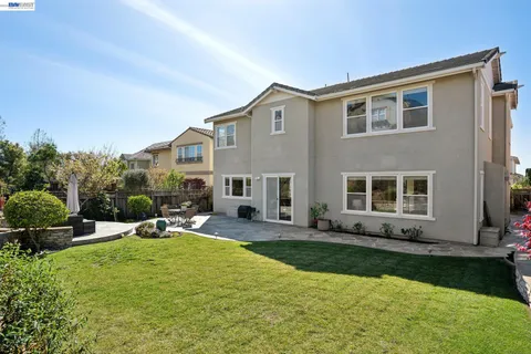 a view of outdoor sitting area with furniture and wooden fence