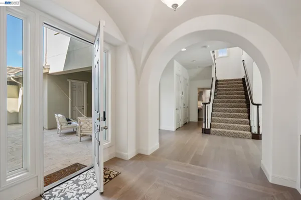 a living room with furniture a fireplace and a large window