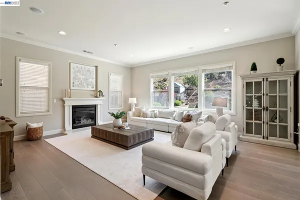 a living room with fireplace furniture and a large window
