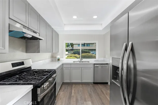 a kitchen with a stove a sink and a refrigerator