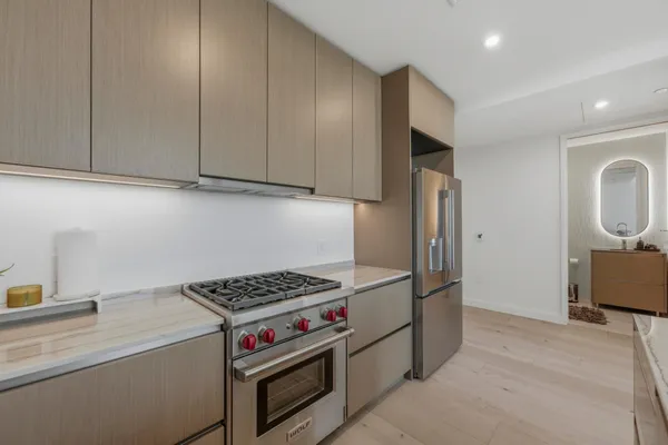 a kitchen with stainless steel appliances granite countertop a stove and a refrigerator