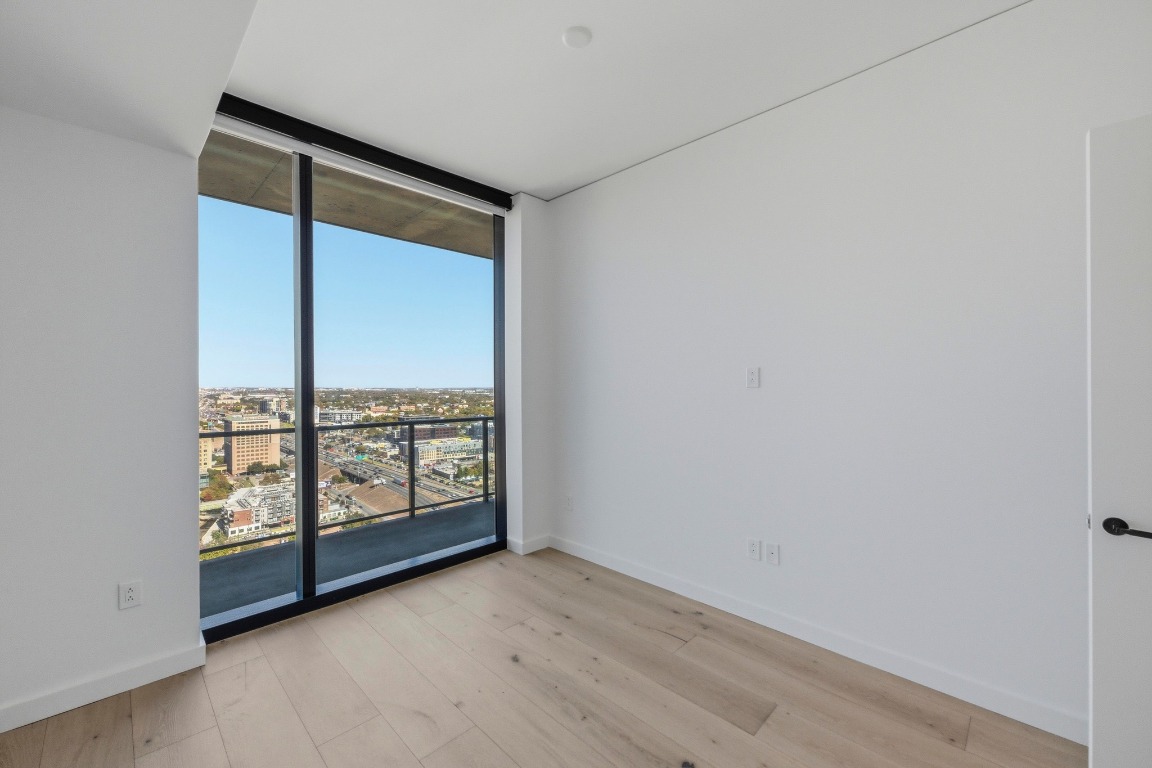 610 Davis Street, Unit 2710 Austin, TX 78701 - Photo 13 of 23 an empty room with windows