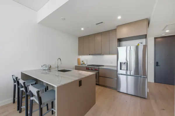 a kitchen with a refrigerator a sink and a stove