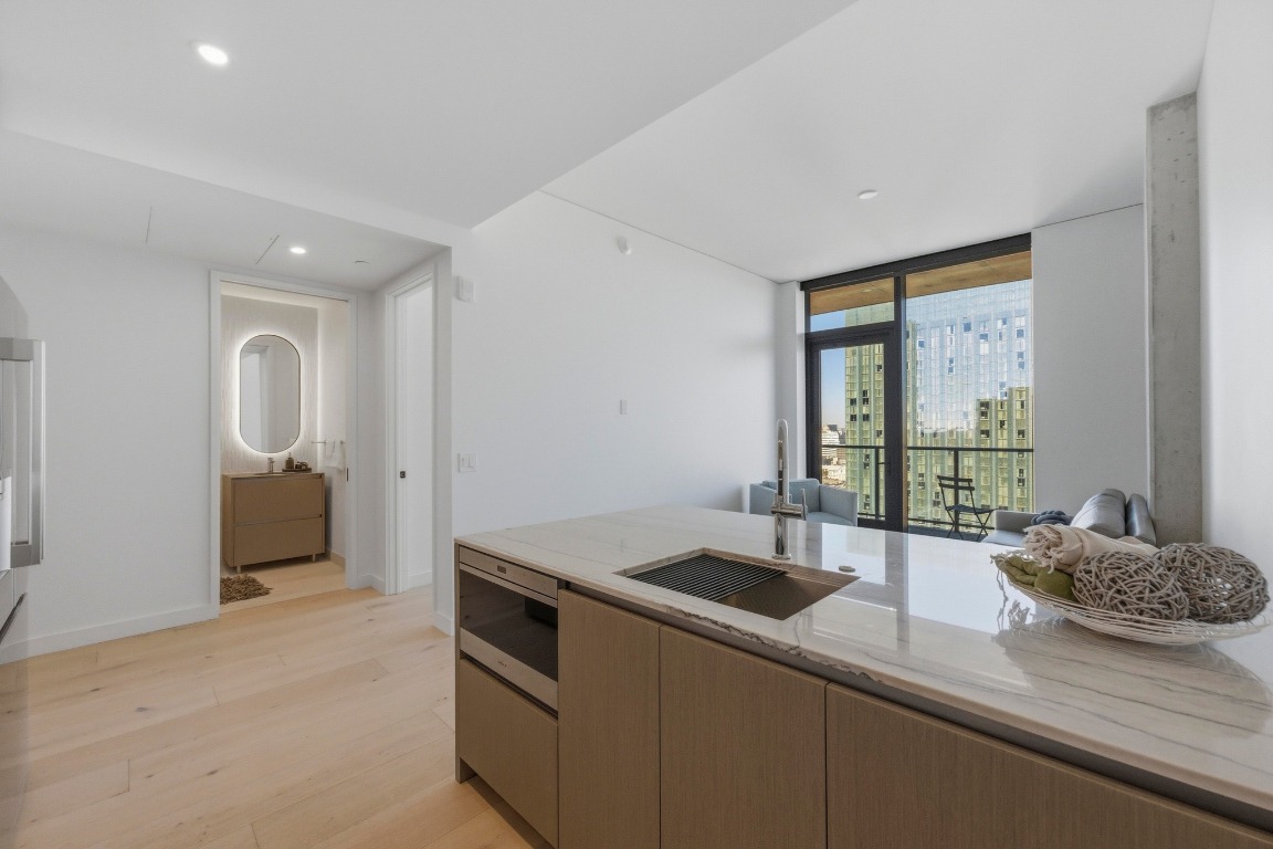 610 Davis Street, Unit 2710 Austin, TX 78701 - Photo 10 of 23 a kitchen with a sink and large window
