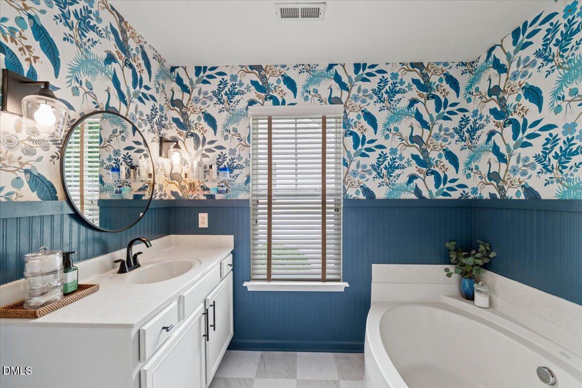 8449 Central Drive Raleigh, NC 27613 - Photo 27 of 38 a bathroom with a sink and a mirror