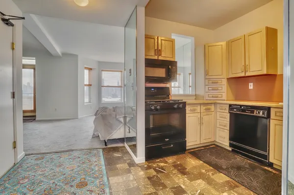 a kitchen with a stove a sink and a refrigerator