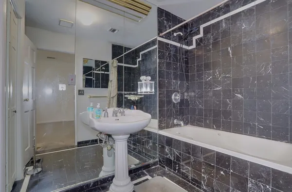 a bathroom with a toilet a sink and mirror