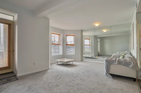 a living room with furniture and large window