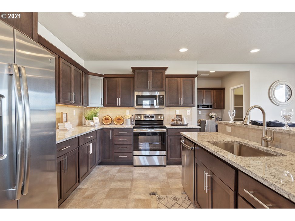 5222 Squirrel Street Springfield, OR 97478 - Photo 8 of 13 a kitchen with a sink stainless steel appliances and cabinets
