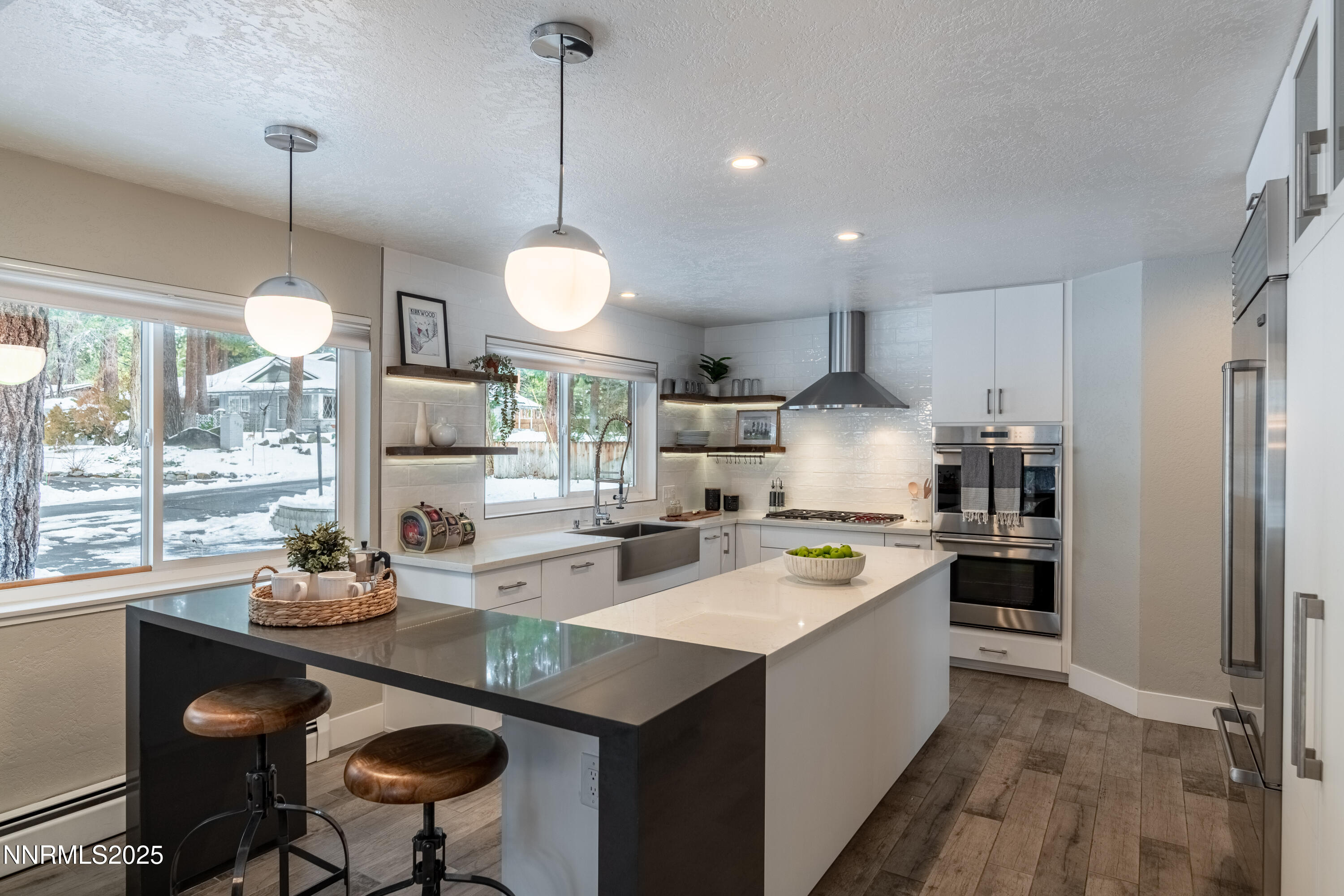 189 Ray Way Zephyr Cove, NV 89448 - Photo 21 of 36 a large kitchen with kitchen island a large counter space appliances and a chandelier