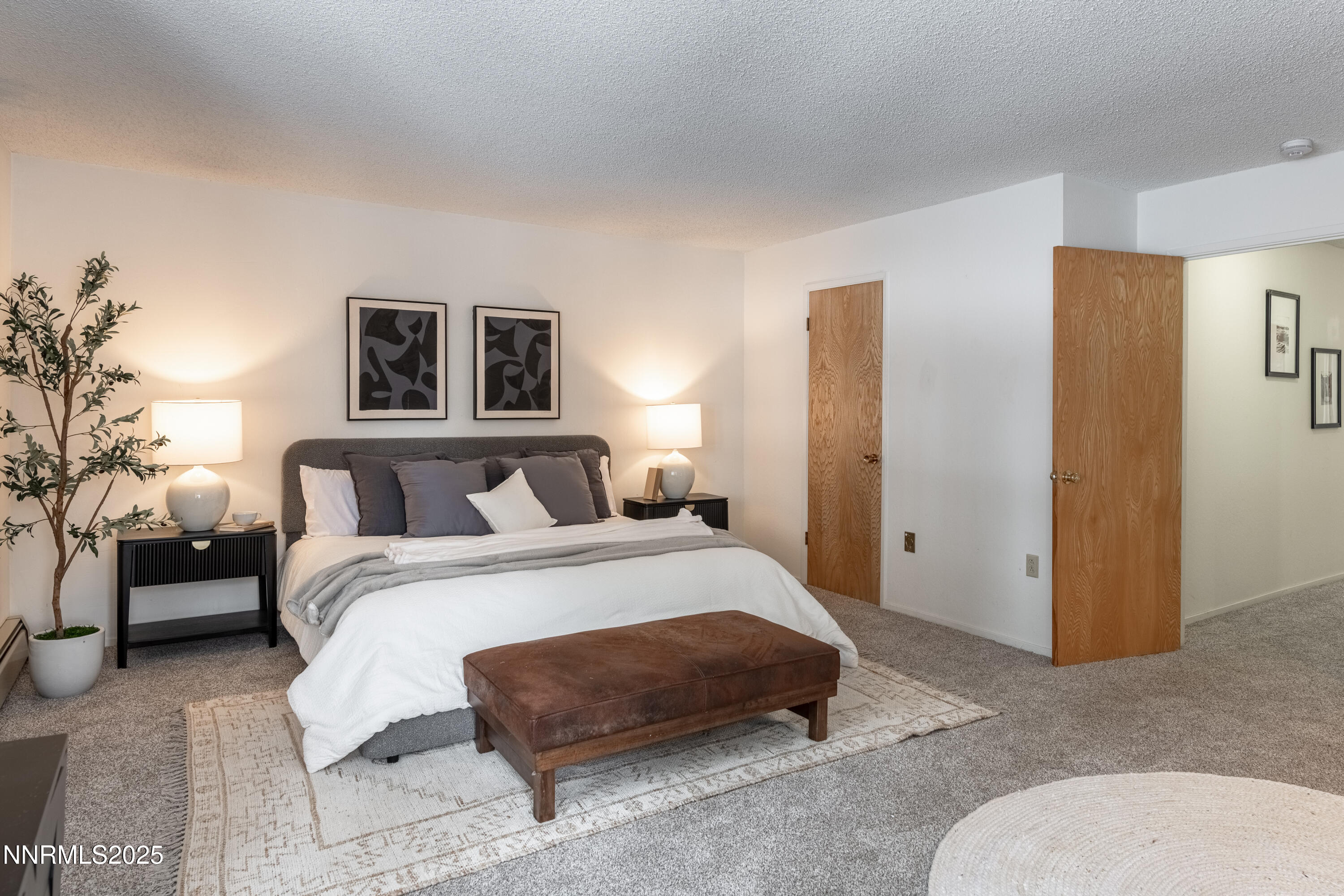 189 Ray Way Zephyr Cove, NV 89448 - Photo 27 of 36 a spacious bedroom with a bed and a couch