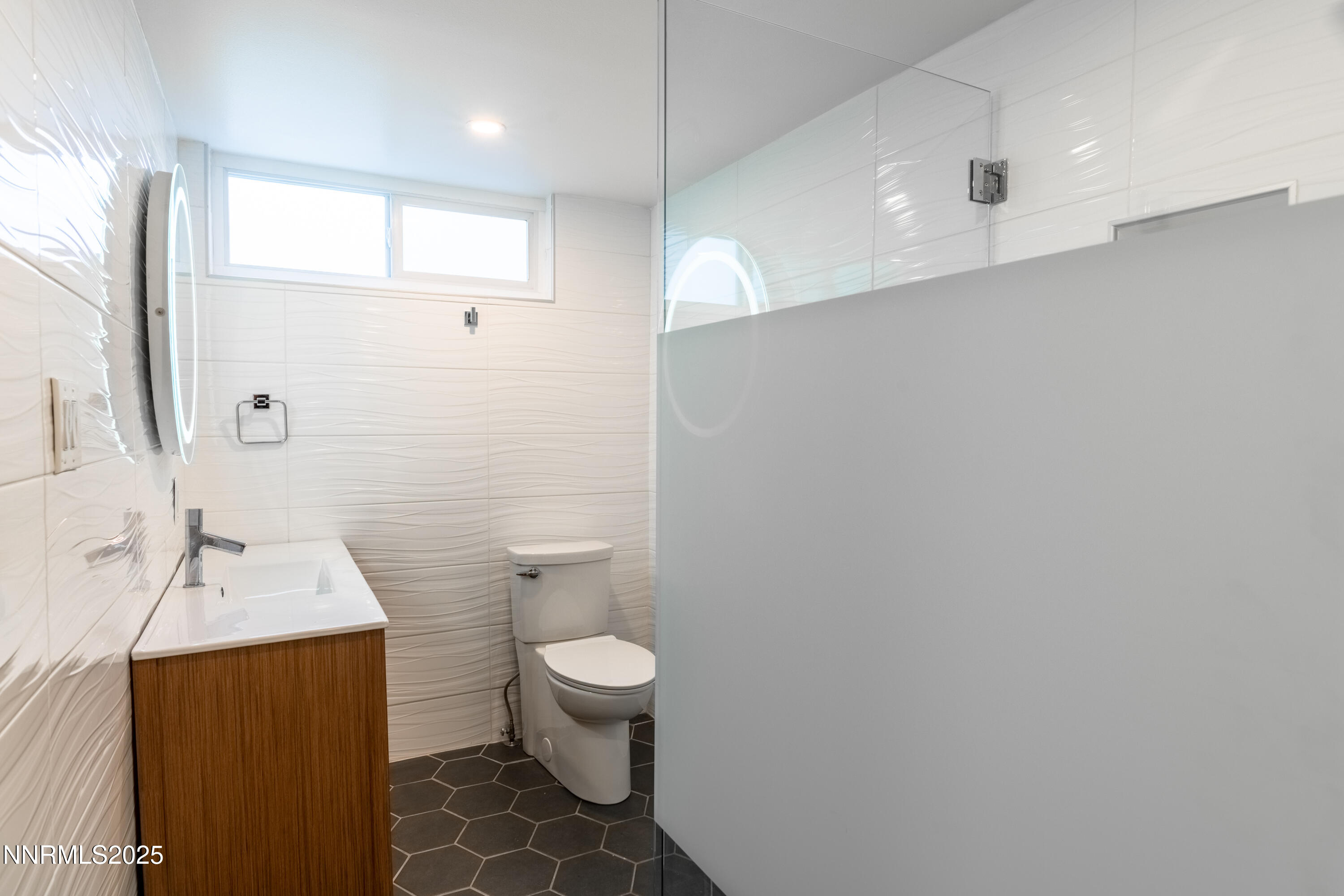 189 Ray Way Zephyr Cove, NV 89448 - Photo 30 of 36 a bathroom with a toilet sink and mirror