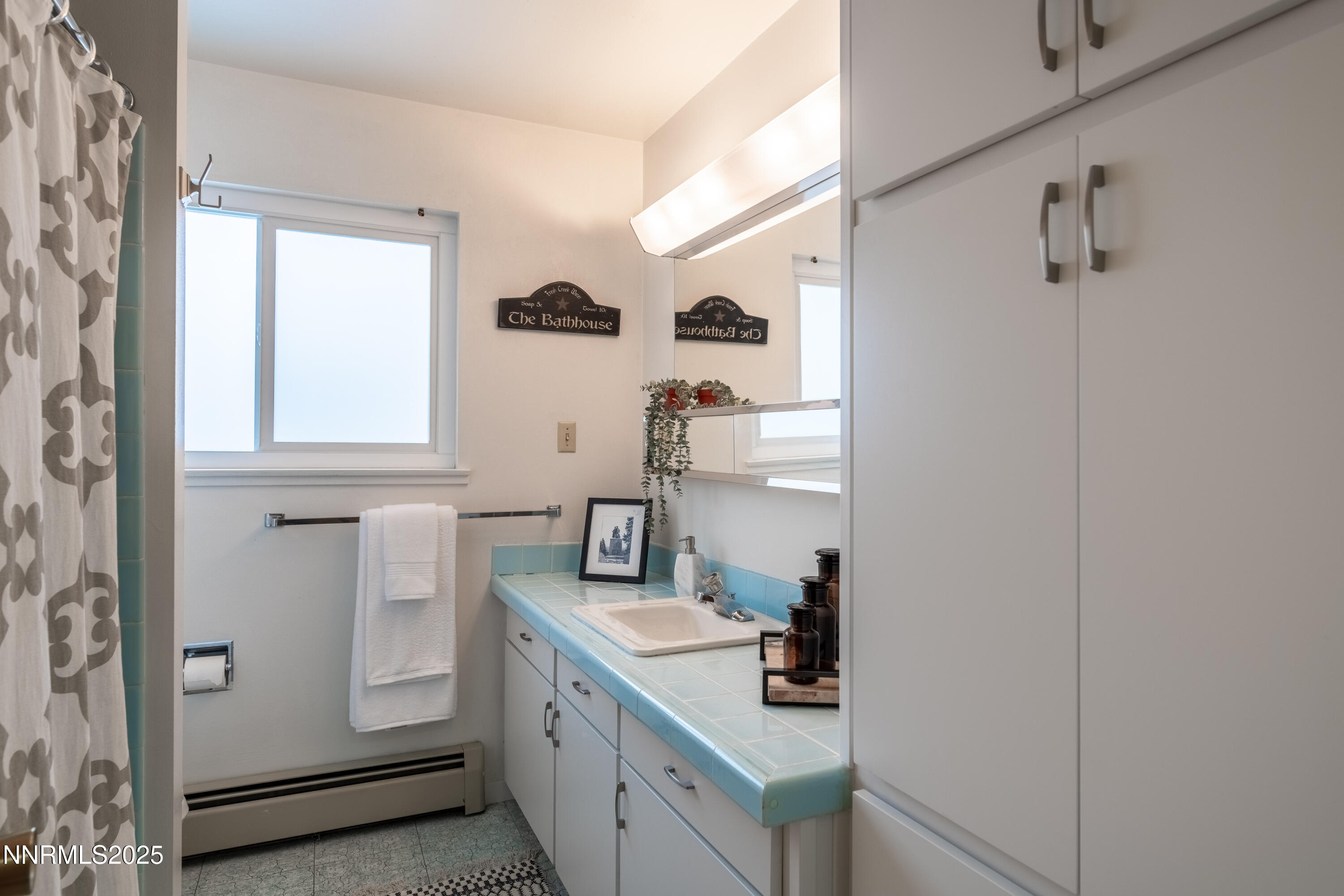 189 Ray Way Zephyr Cove, NV 89448 - Photo 32 of 36 a bathroom with a sink and a mirror