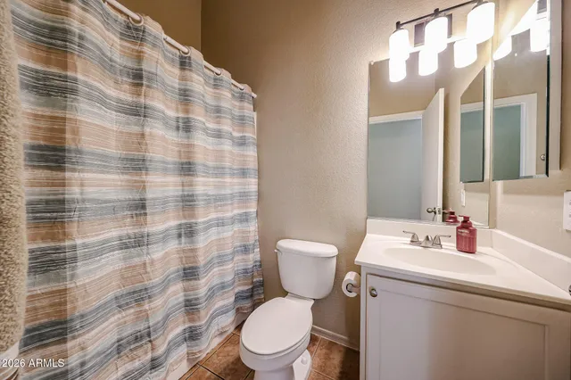 a white toilet sitting next to a bathroom sink