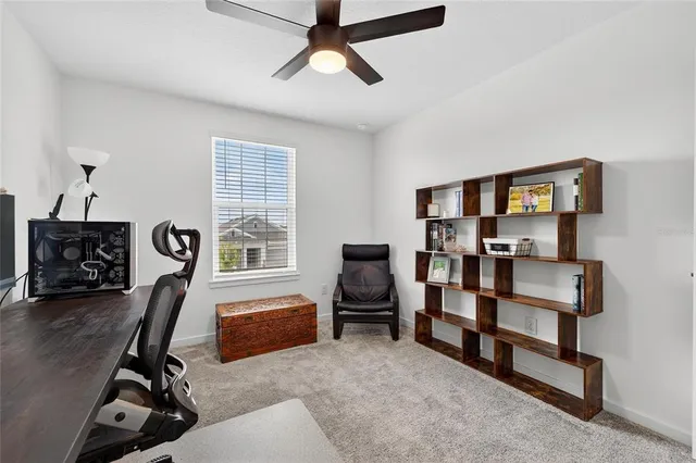 a bedroom with a bed and a flat tv screen on dresser