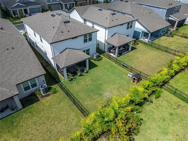 an aerial view of houses with yard