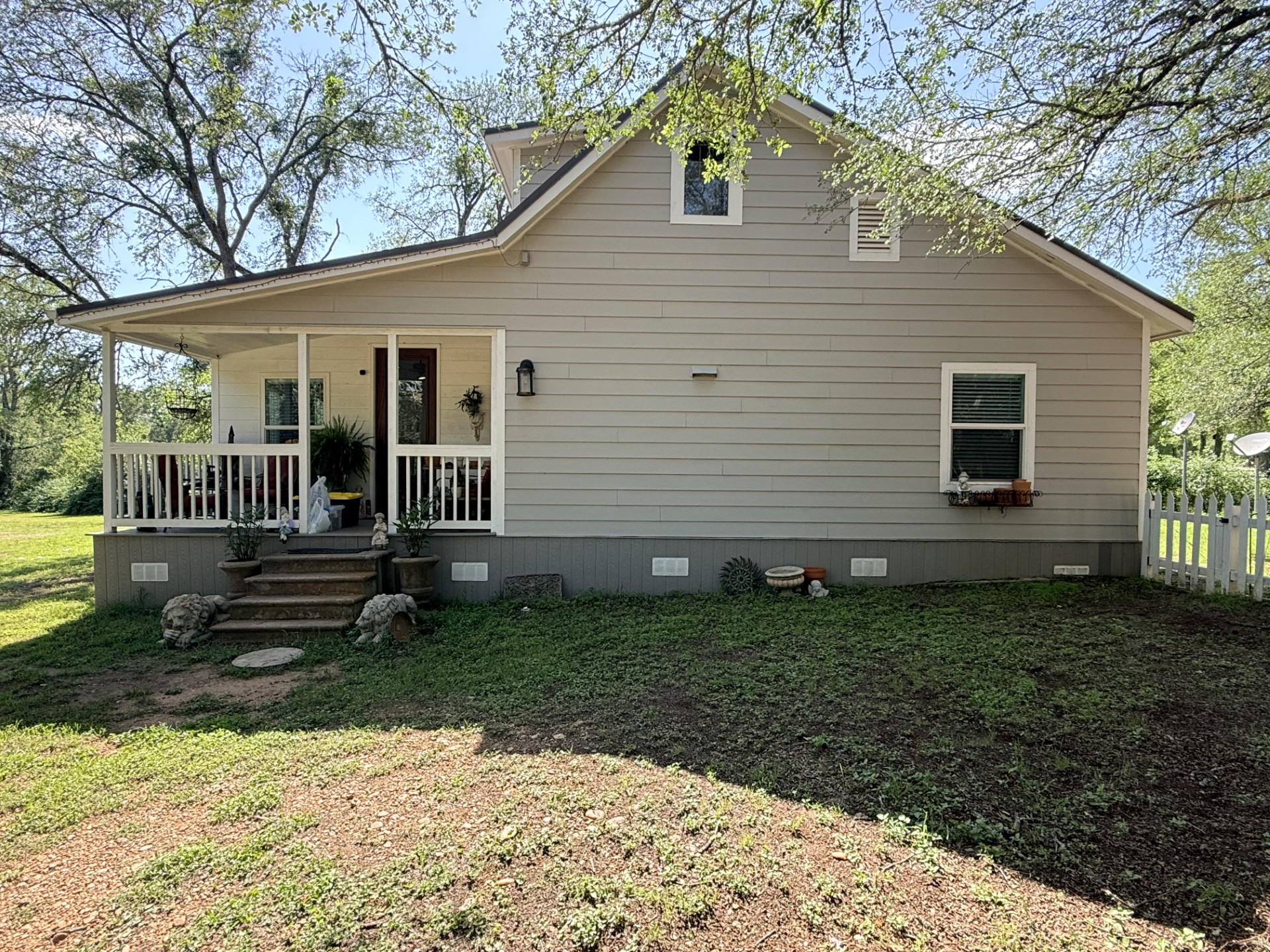 227 Crooked Hollow Road Elgin, TX 78621 - Photo 1 of 11 a front view of a house with garden