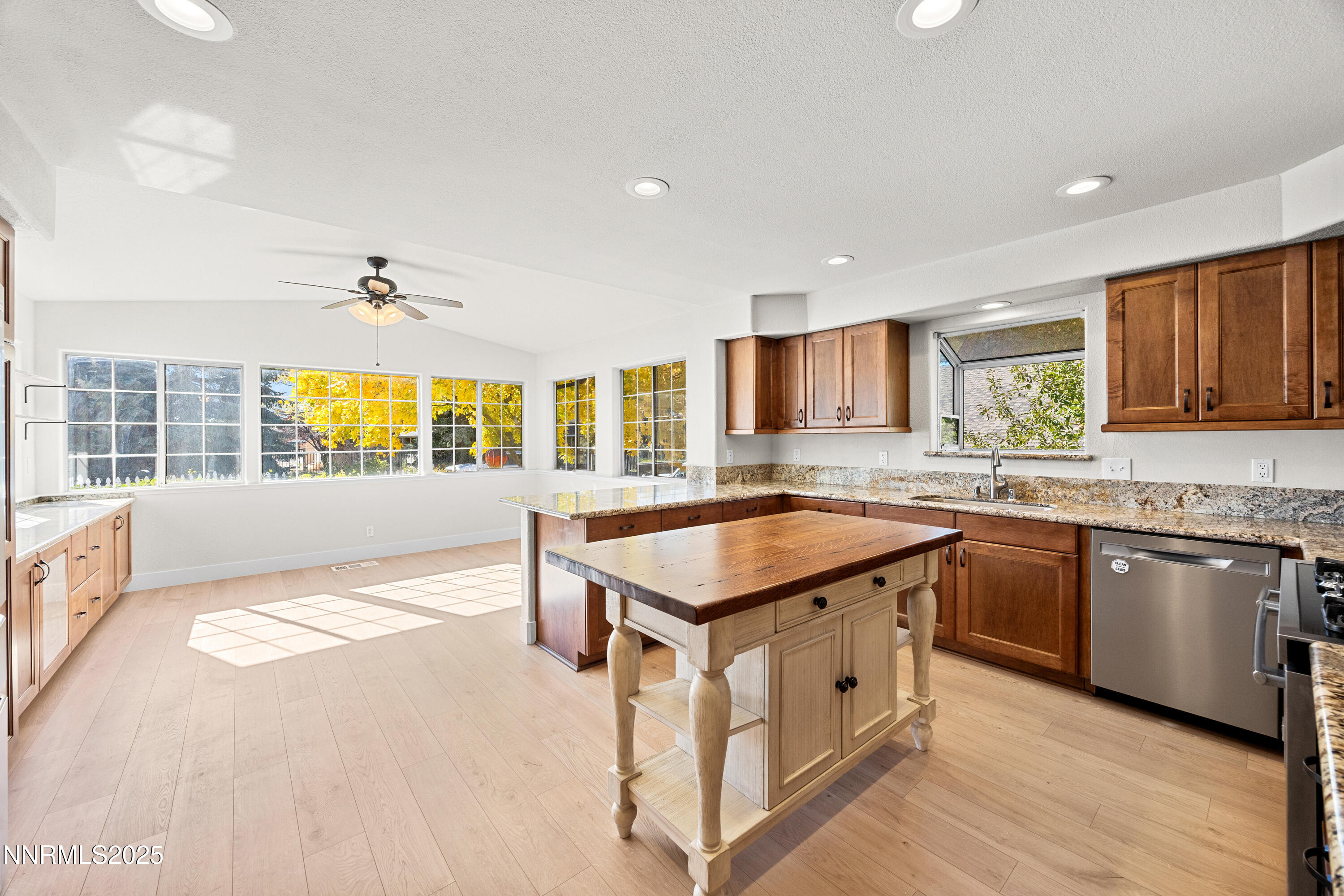 a kitchen with stainless steel appliances granite countertop a sink stove and wooden cabinets