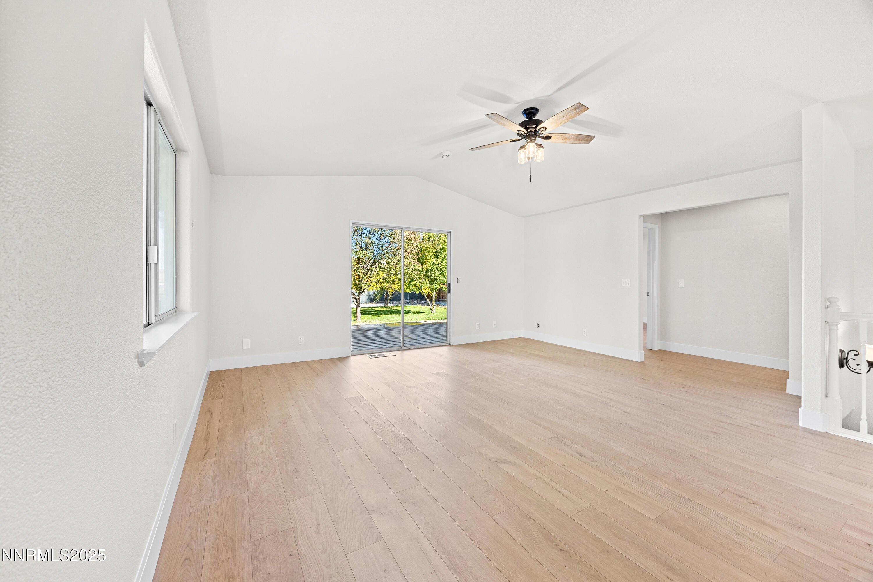3510 Comstock Drive Reno, NV 89512 - Photo 14 of 37 an empty room with windows and chandelier fan