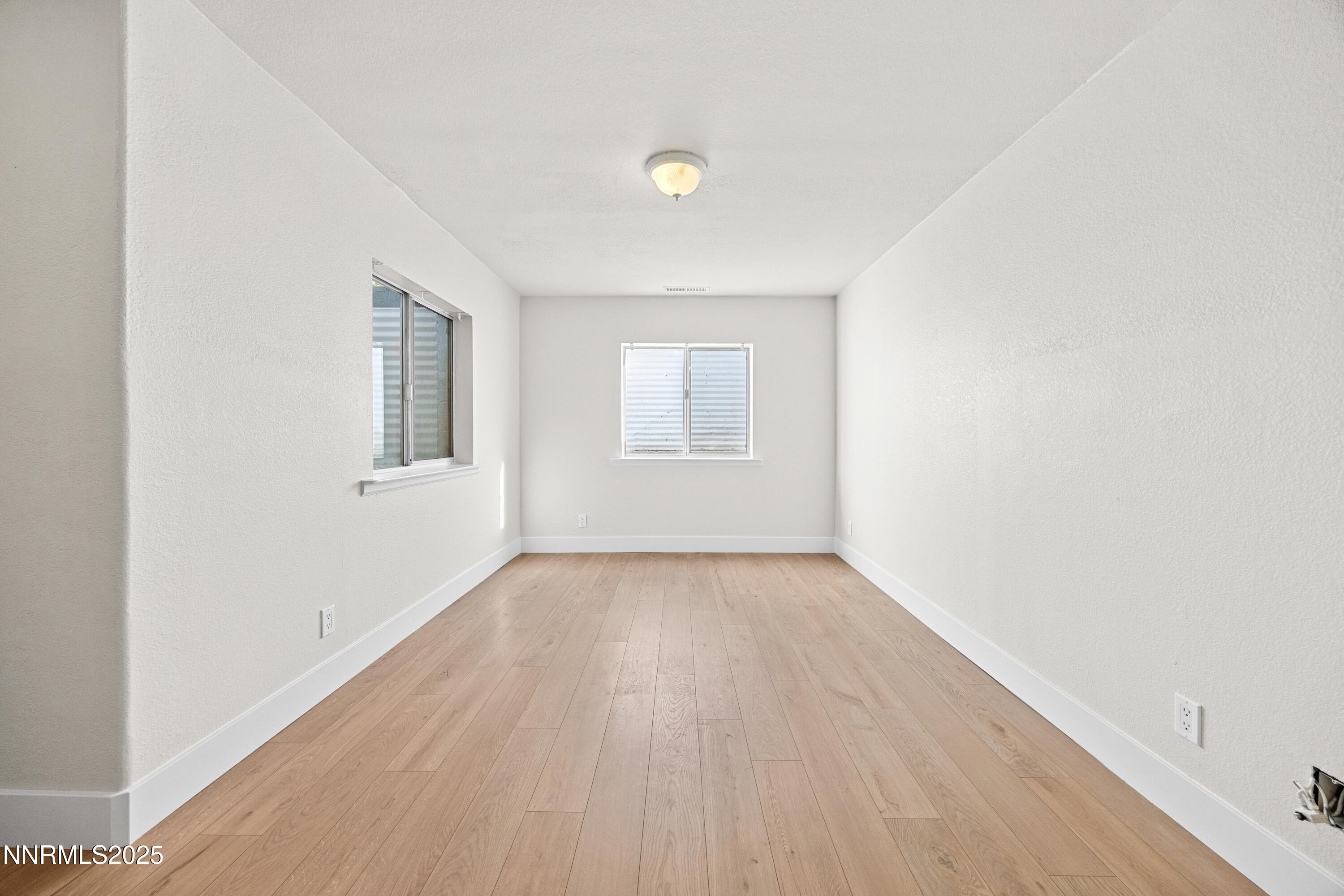 3510 Comstock Drive Reno, NV 89512 - Photo 26 of 37 an empty room with wooden floor and windows