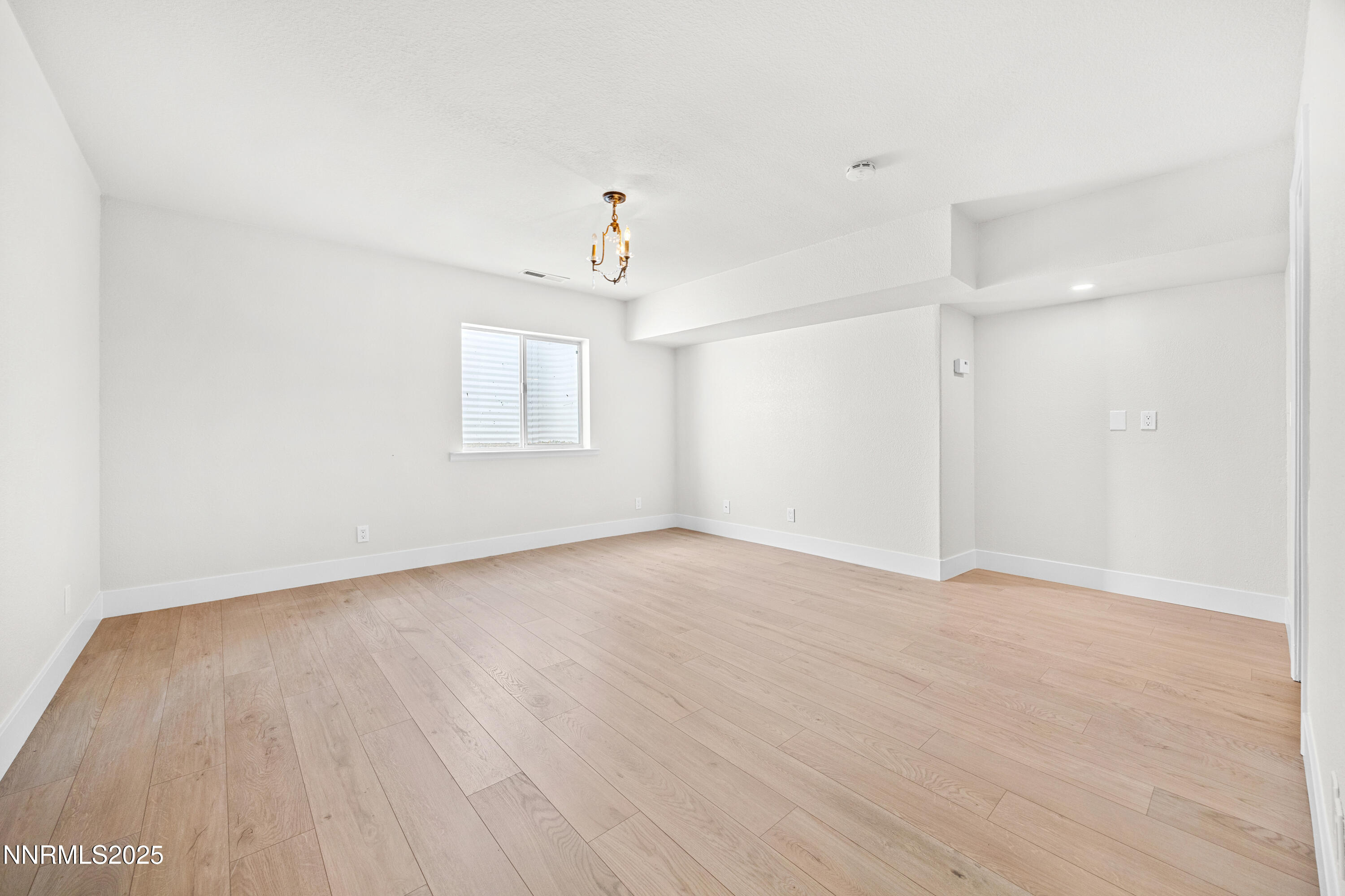 3510 Comstock Drive Reno, NV 89512 - Photo 27 of 37 a view of an empty room with wooden floor and a window