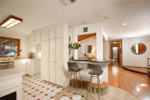 a kitchen with stainless steel appliances kitchen island granite countertop a refrigerator and a stove top oven