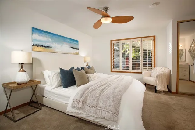 a bedroom with bed and a large mirror