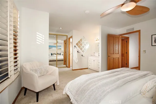 a spacious bedroom with a bed and a couch