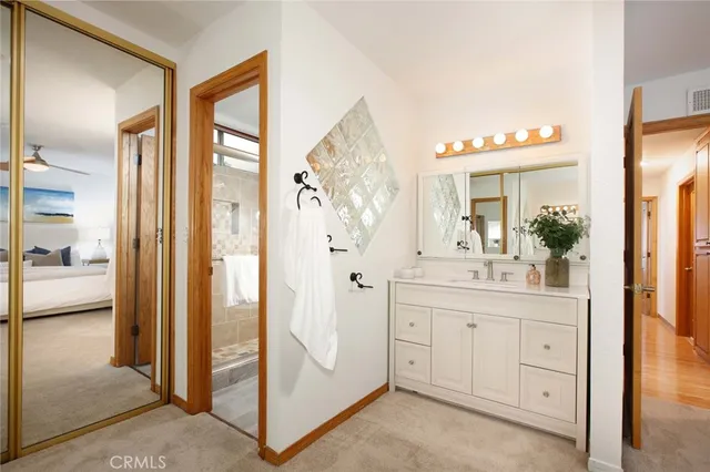 a spacious bathroom with a glass shower door and a sink