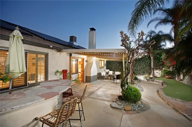 a living room with patio furniture and a patio