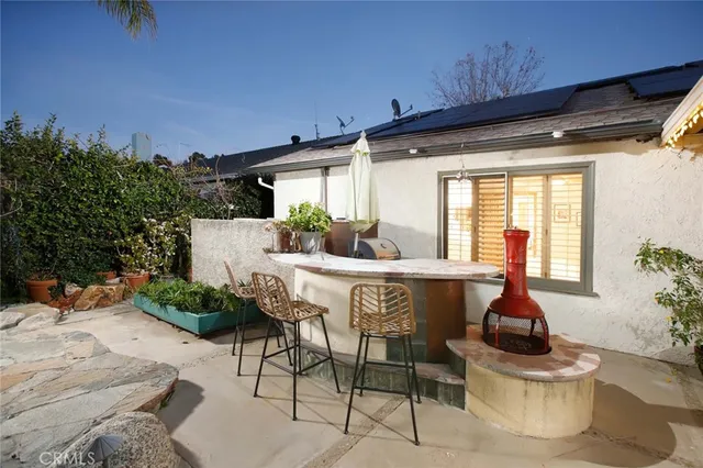 a dining room with furniture and a potted plant