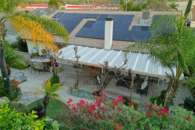 an aerial view of a city with lots of residential buildings ocean and mountain view in back