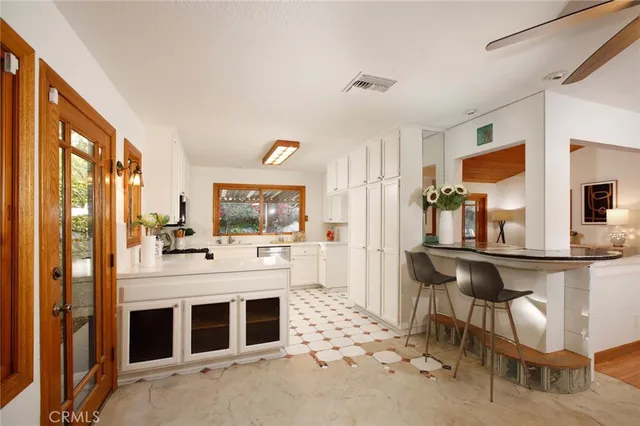a large kitchen with a table and chairs