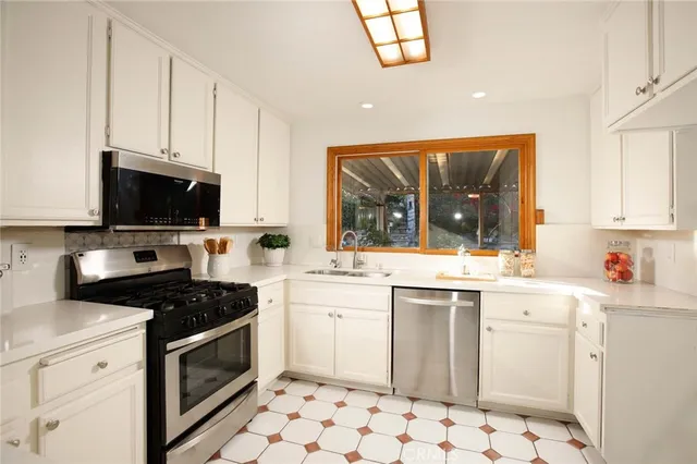 a kitchen with a sink stove and microwave