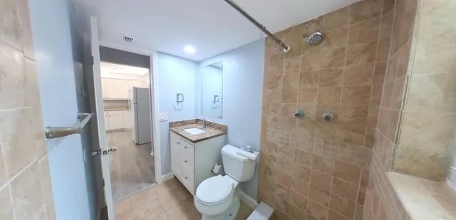 a bathroom with a toilet and a shower