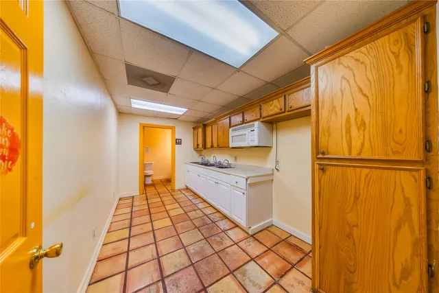 an empty room with a window and a ceiling fan
