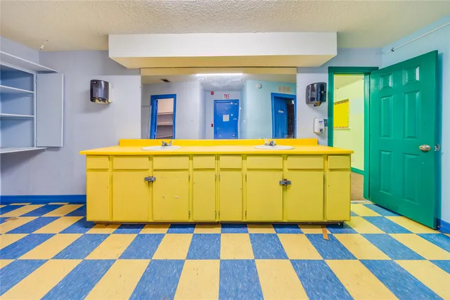 a kitchen with stainless steel appliances granite countertop a refrigerator a stove and a window