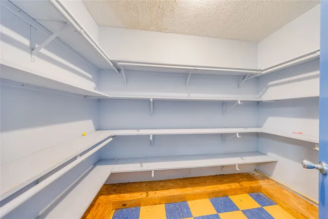 a view of a hallway with wooden shelves