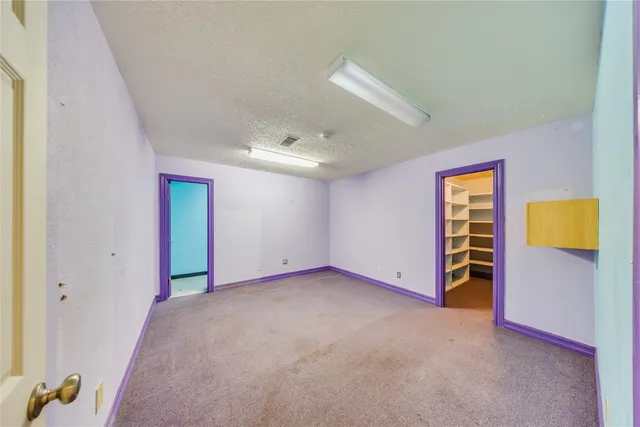 a view of hallway with stairs and a furniture